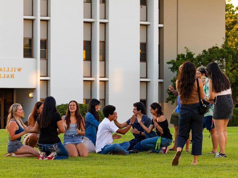 Image card - First-year students on grass